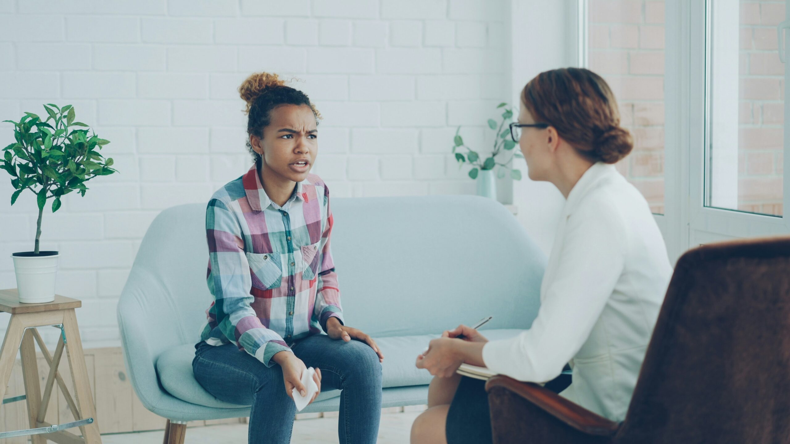 Werknemer in een gespannen gesprek met een gespreksbegeleider over een arbeidsconflict